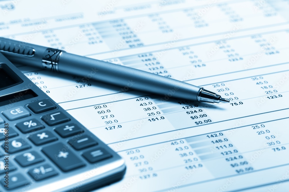 Pen and Calculator on Financial Figures Pen and Calculator on Financial Figures