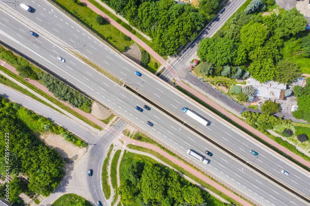 Traffic trails on highway intersection. Aerial View. Green Forest Traffic trails on highway intersection. Aerial View. Green Forest