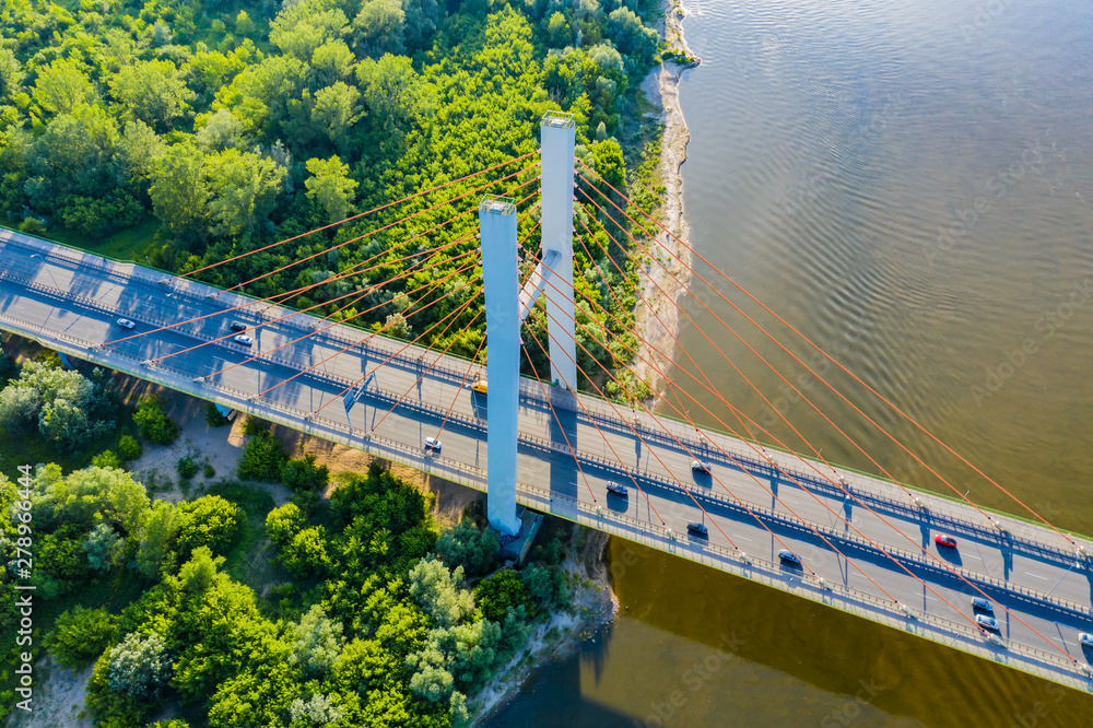 Fototapeta premium Aerial Drone Flight top down View of freeway busy city rush hour heavy traffic jam highway. Aerial view of the vehicular intersection, traffic at peak hour with cars on the road. Bridge Top View