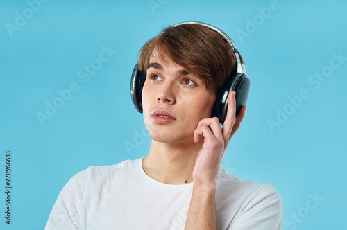 young man listening to music on headphones