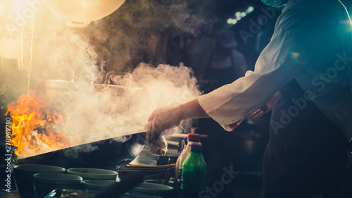 Chef stir fry in wok photo