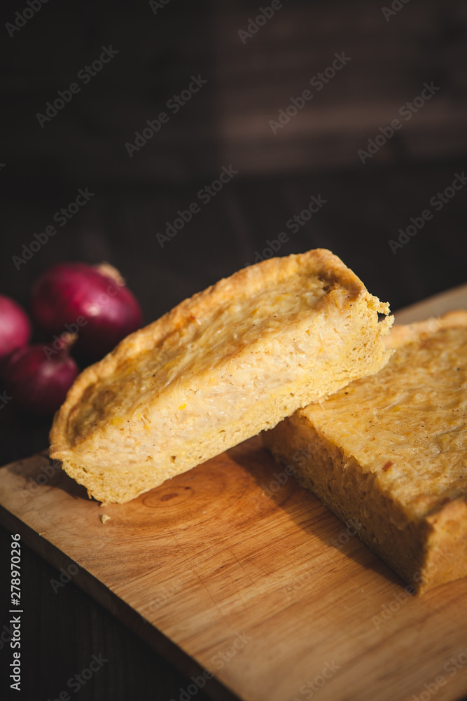 french onion cake on dark wooden background with red onions french onion cake on dark wooden background with red onions