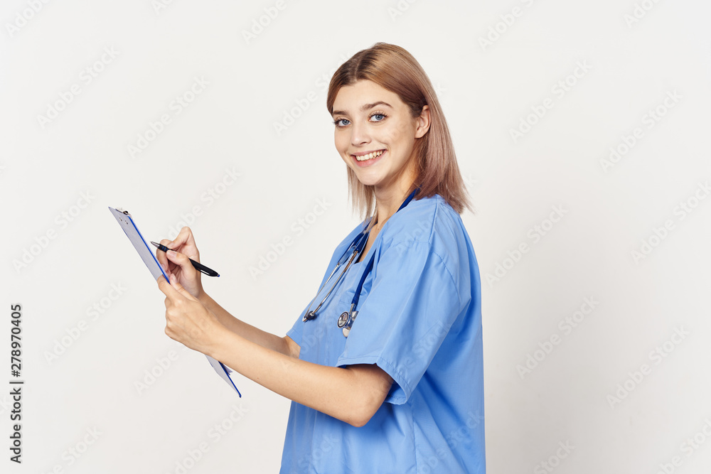 young doctor writing on clipboard