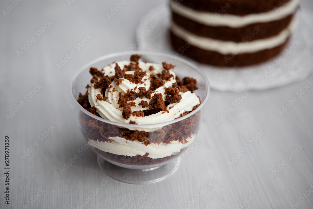portioned chocolate cake with white cream in a cup portioned chocolate cake with white cream in a cup