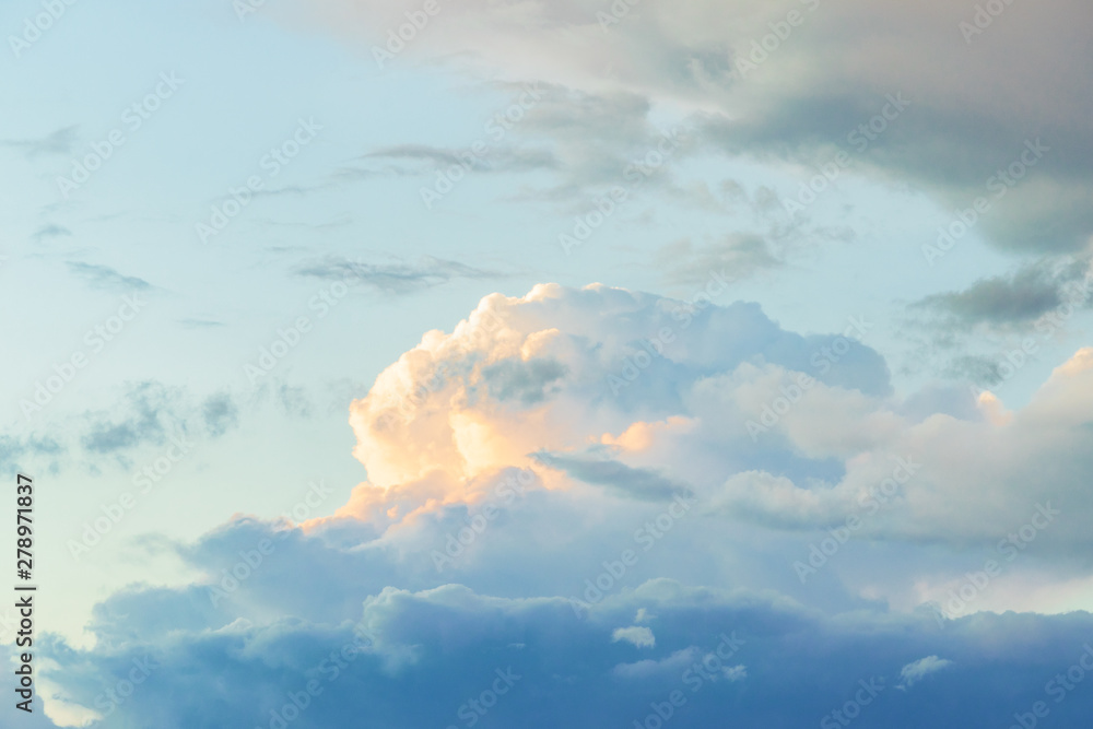 Summer blue sky with a thundercloud. Large fluffy white clouds. Summer blue sky with a thundercloud. Large fluffy white clouds.