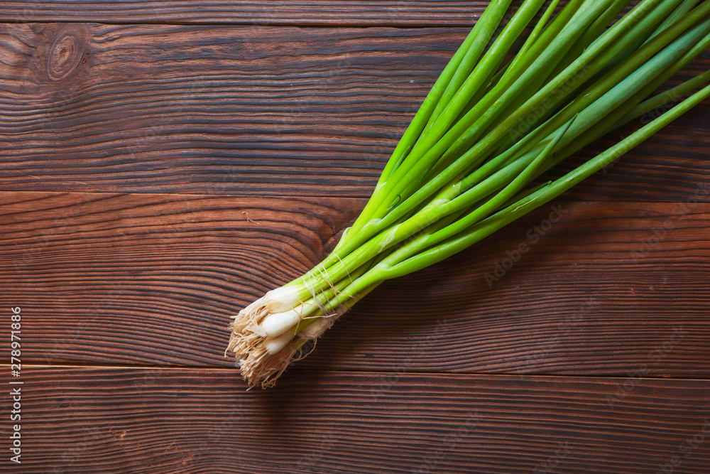 Fresh green onions on a cutting board close-up Fresh green onions on a cutting board close-up