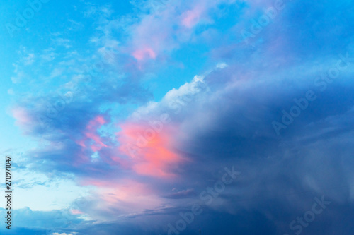 Summer blue sky with a thundercloud. Large fluffy white clouds.