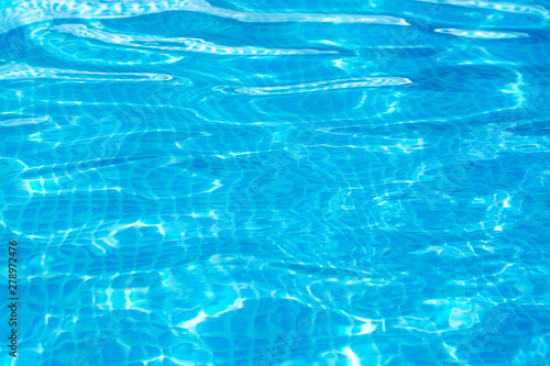 background of bright blue clear water in the pool