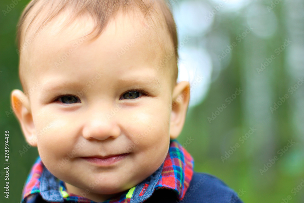 Portrait of a two-year-old boy in a dark blue sweater of Asian appearance outdoors in the summer close-up. Portrait of a two-year-old boy in a dark blue sweater of Asian appearance outdoors in the summer close-up.