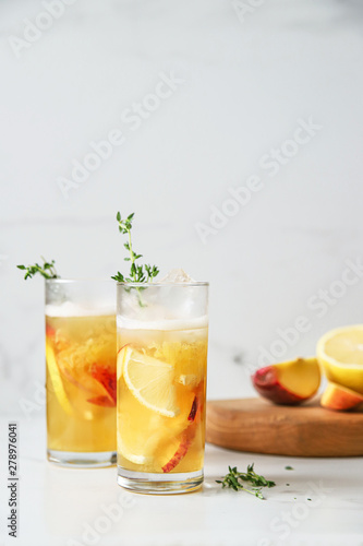 Fresh peach lemonade on light marble background