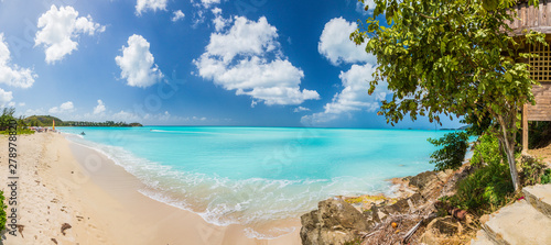Panorama picture of whity sandy beach and turquoise waters on carrebian island of St. Maarten