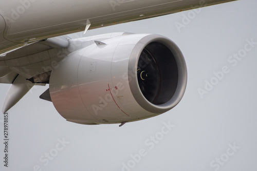 Airplane turbofan and a part of a wing and fuselage photo