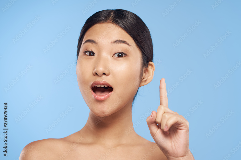 young woman with finger on her lips