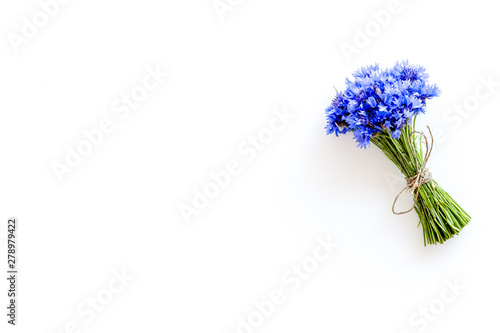 Field flowers design with bouquet of blue cornflowers on white background top view space for text