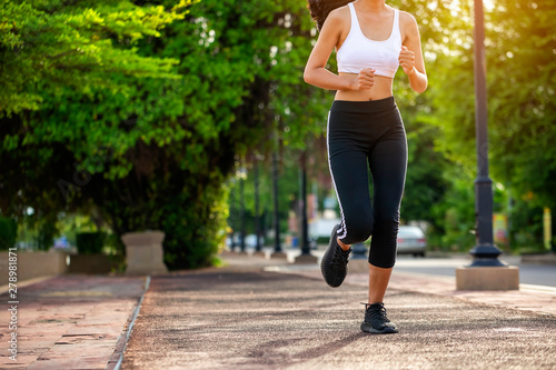 Beautiful woman jogger outdoor living healthy lifestyle in city park. Concept sport and a healthy lifestyle in the city.