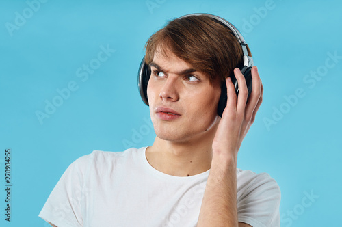 young man listening to music with headphones