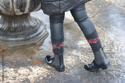 Autumn Boots. Woman with waterproof shiny black boots. Selective focus.
