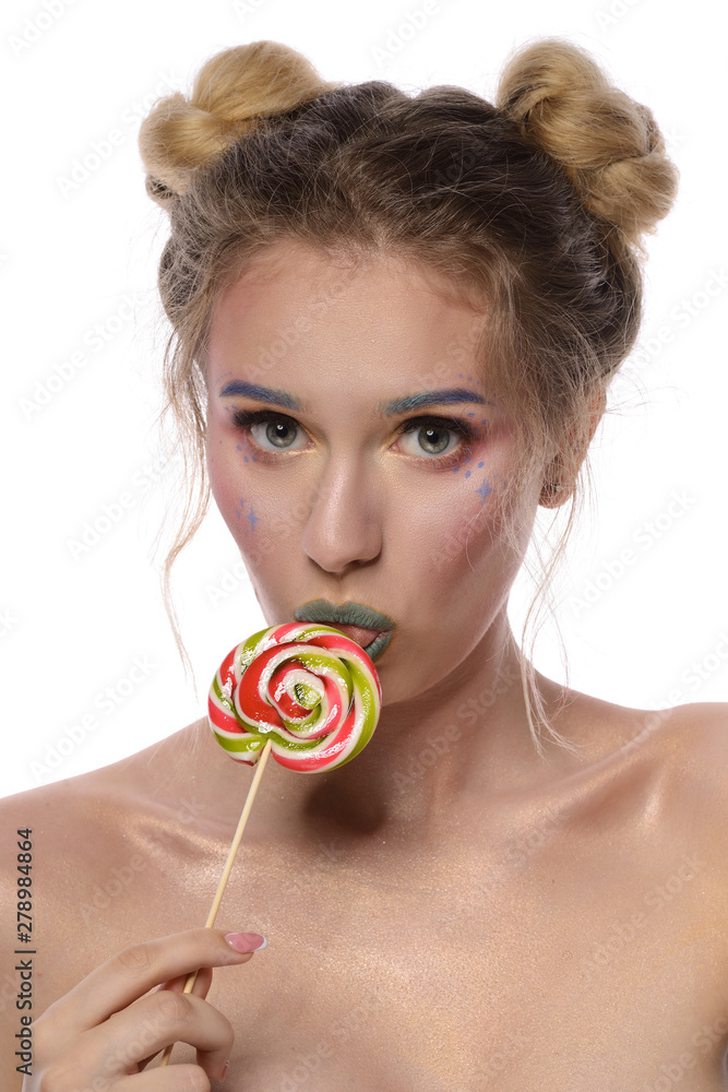 Portrait of a young beautiful girl with a lollipop. Creative makeup. Green lips.On a white background