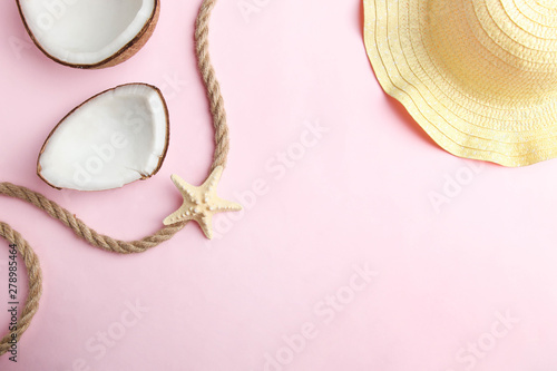 Pieces of natural coconut and beach straw hat