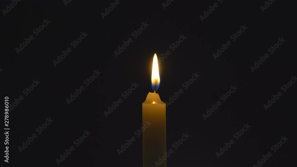 A single white candle burning. Looping for use as a background or illustration of remembrance or celebration. The wind tries to put out the flame, but it recovers each time. The eternal flame. A single white candle burning. Looping for use as a background or illustration of remembrance or celebration. The wind tries to put out the flame, but it recovers each time. The eternal flame.