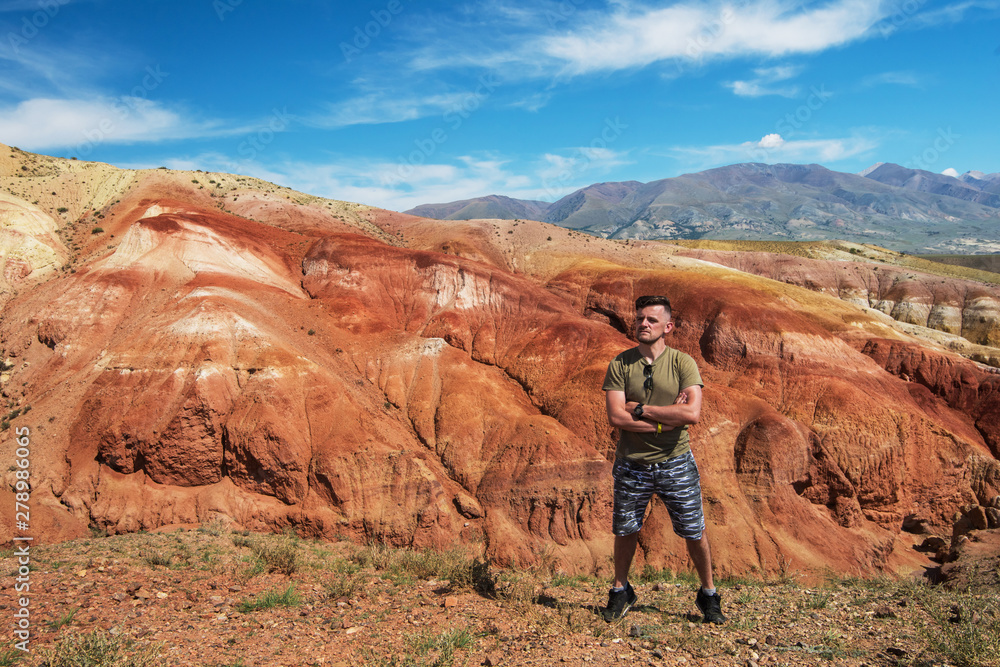Man in Valley of Mars landscapes in the Altai Mountains, Russia Man in Valley of Mars landscapes in the Altai Mountains, Russia