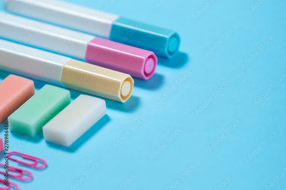 Stationery, marker and paperclip on blue pastel background Stationery, marker and paperclip on blue pastel background