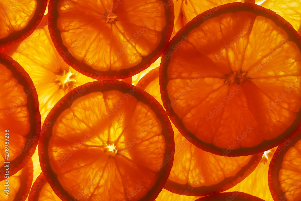 Slices of pulp and zest ripe orange with backlighting as a textural background, the substrate. Full screen, Close-up