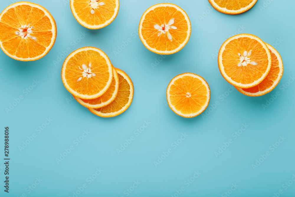 Slices and slices of orange pulp on a bright blue background as a textural background, the substrate. Full screen Flat lay, top view. Food background Slices and slices of orange pulp on a bright blue background as a textural background, the substrate. Full screen Flat lay, top view. Food background