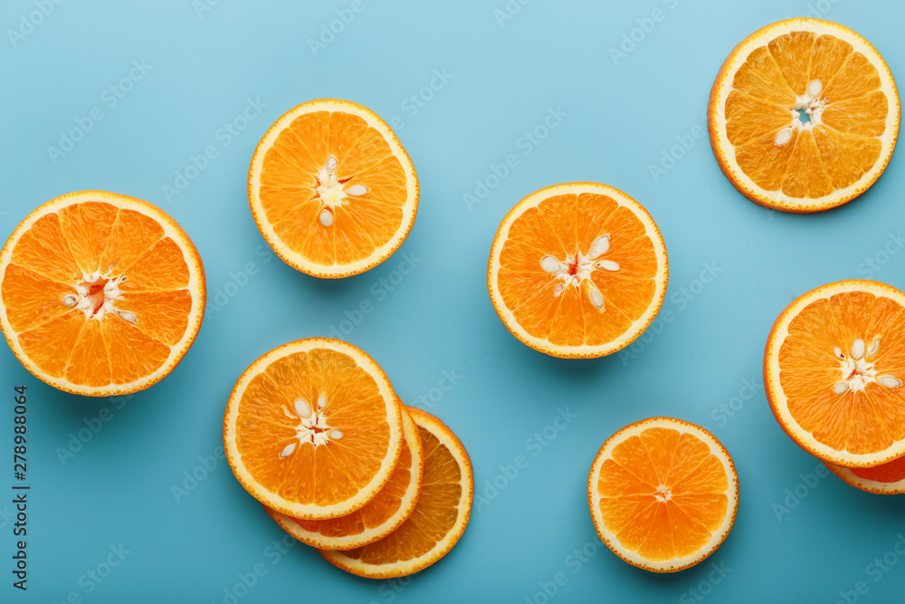 Slices and slices of orange pulp on a bright blue background as a textural background, the substrate. Full screen Flat lay, top view. Food background Slices and slices of orange pulp on a bright blue background as a textural background, the substrate. Full screen Flat lay, top view. Food background