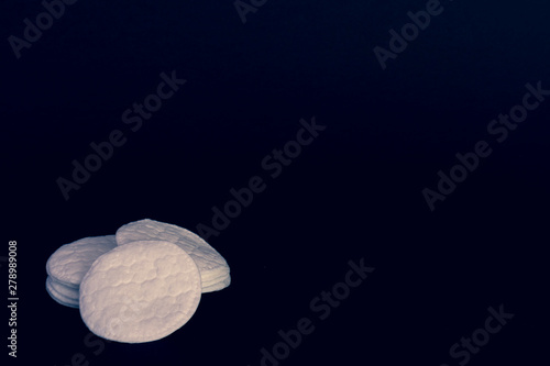 cotton pads on black background