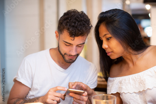 Young mix couple asian European in the restauran laughing 