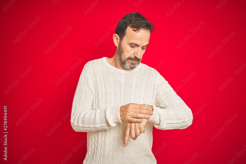 Handsome middle age senior man with grey hair over isolated red background Checking the time on wrist watch, relaxed and confident Handsome middle age senior man with grey hair over isolated red background Checking the time on wrist watch, relaxed and confident