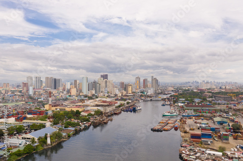 The urban landscape of Manila, with slums and skyscrapers. Sea port and residential areas. The contrast of poor and rich areas. The capital of the Philippines, view from above. © Tatiana Nurieva
