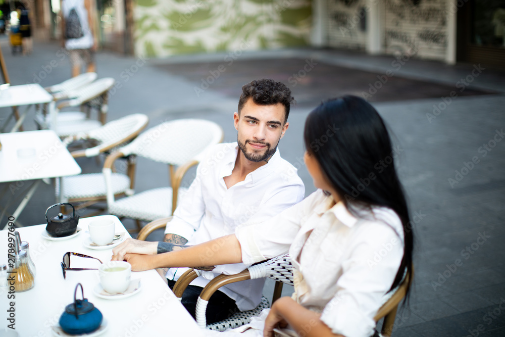 Obraz premium young mix couple asian and caucasian breakfast in the street happy