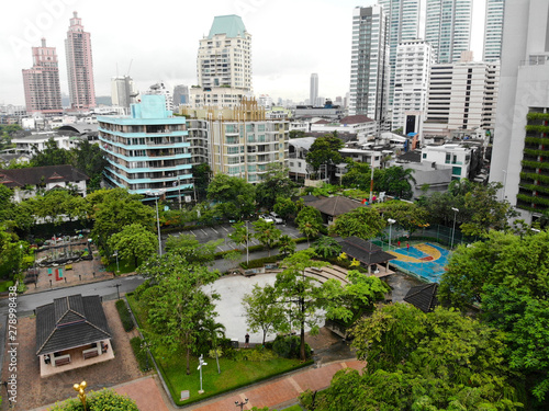 Aerial view Benchasiri Park next Sukhumvit street, Bangkok, Thailand. Aerial view of Bangkok Benchasiri Park with little lake and skyscraper on the background.