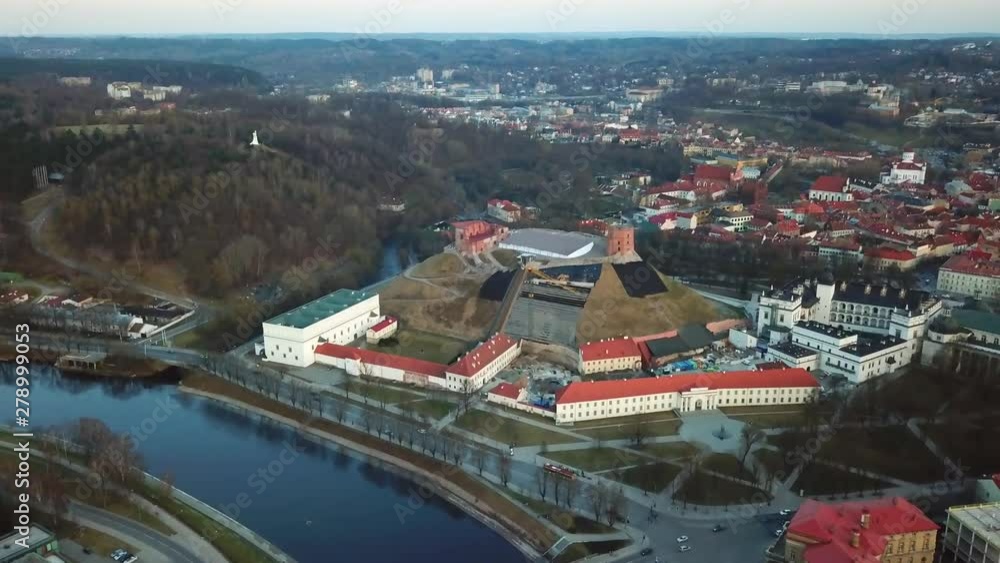 Aerial, drone shot over the Neris river, towards the Gediminas castle and the national museum, in Vilnius. at sunset, on a sunny, spring evening, in Lithuania Aerial, drone shot over the Neris river, towards the Gediminas castle and the national museum, in Vilnius. at sunset, on a sunny, spring evening, in Lithuania