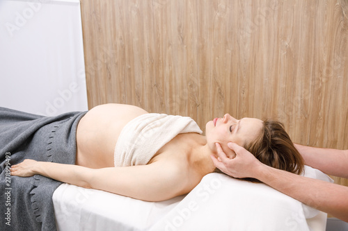 Photography Pregnant woman receiving osteopathic treatment of her head