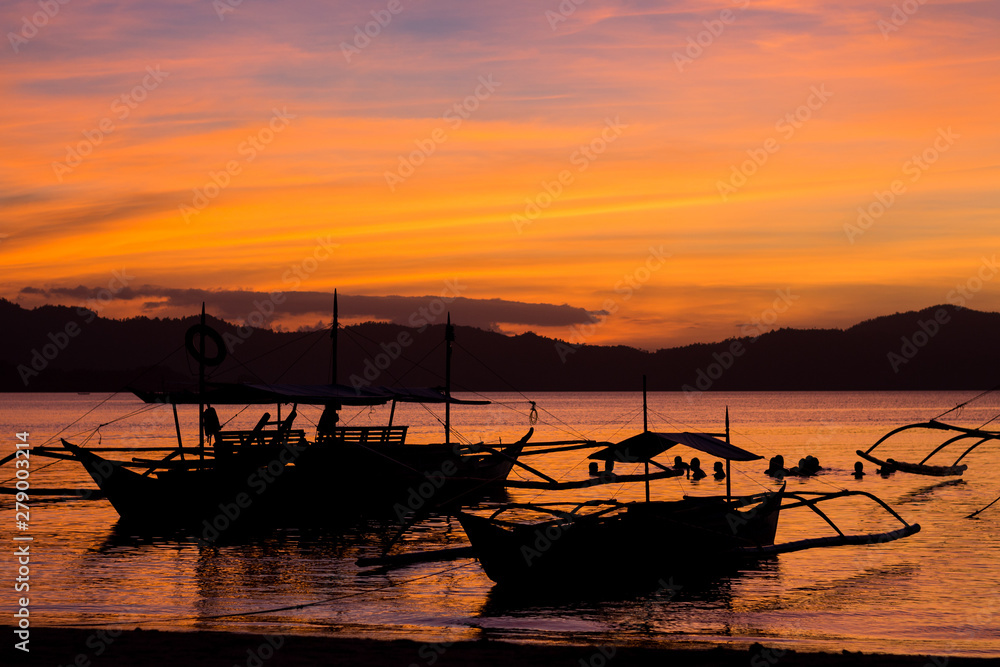 Sunset with typical boats in Port Barton, Philippines, Palawan Island Sunset with typical boats in Port Barton, Philippines, Palawan Island