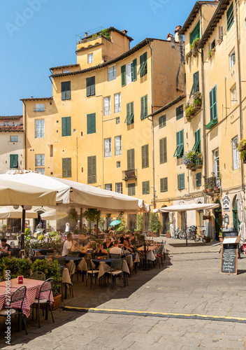 Amphitheater square with restaurants, bars and tourists in old town Lucca, Tuscany, Italy © EleSi