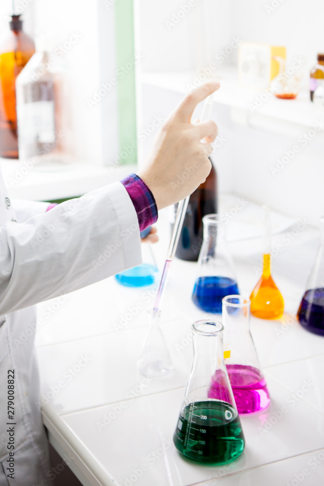 lab technician mixes liquids in flasks lab technician mixes liquids in flasks