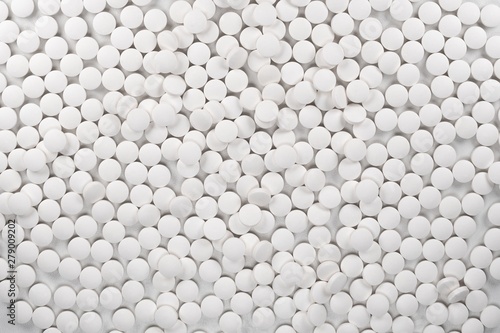 White pills  tablets on white background.