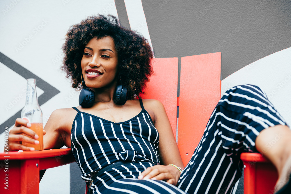 © Gerald Carter/Creative Flame - Woman relaxing outdoors with beverage
