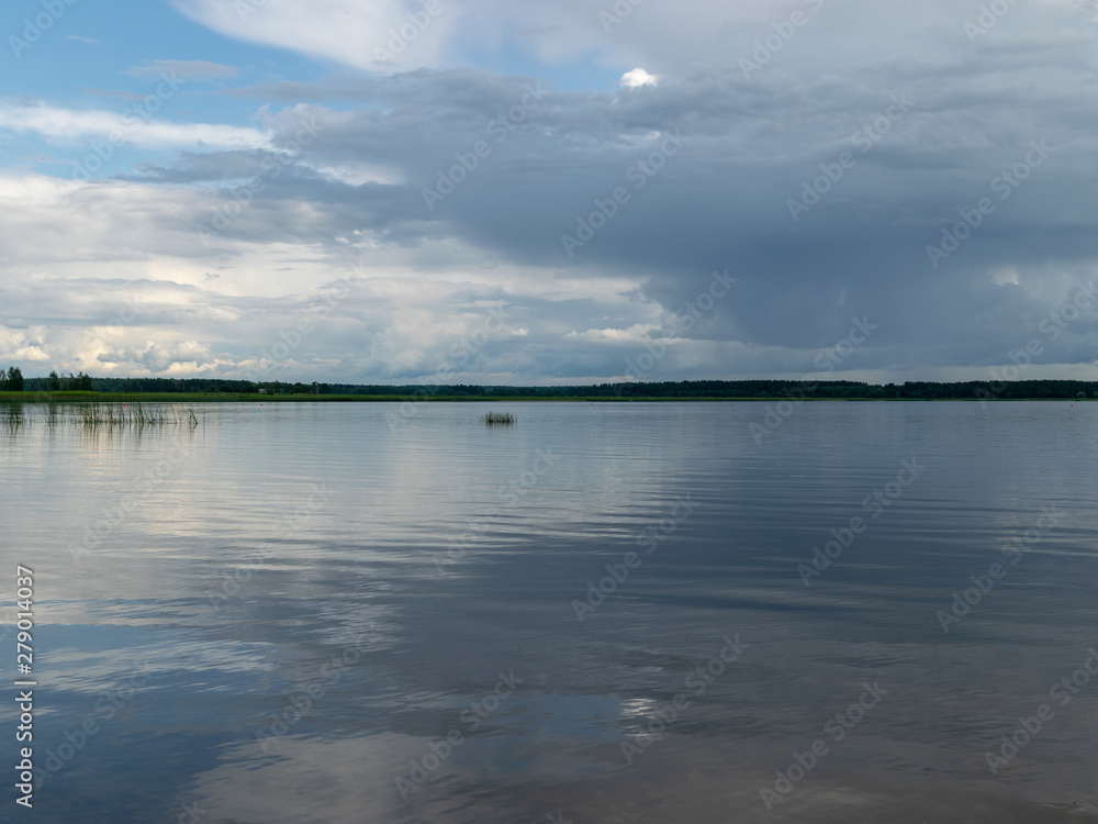 Beautiful, peaceful lake shore with storm clouds, wonderful reflections, Lake Burtnieks, Latvia
