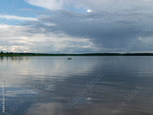 Beautiful, peaceful lake shore with storm clouds, wonderful reflections, Lake Burtnieks, Latvia