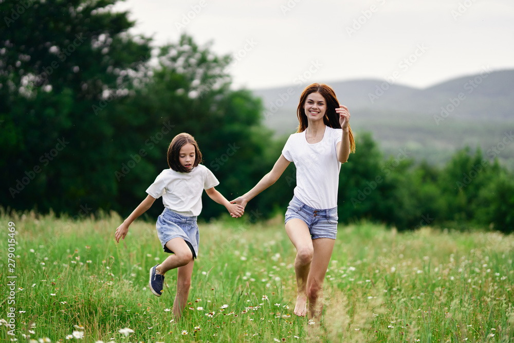 mother and daughter running in the field mother and daughter running in the field