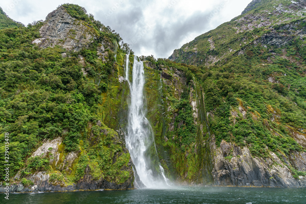 waterfall in the mountains at milford sound, fjordland, new zealand 14
