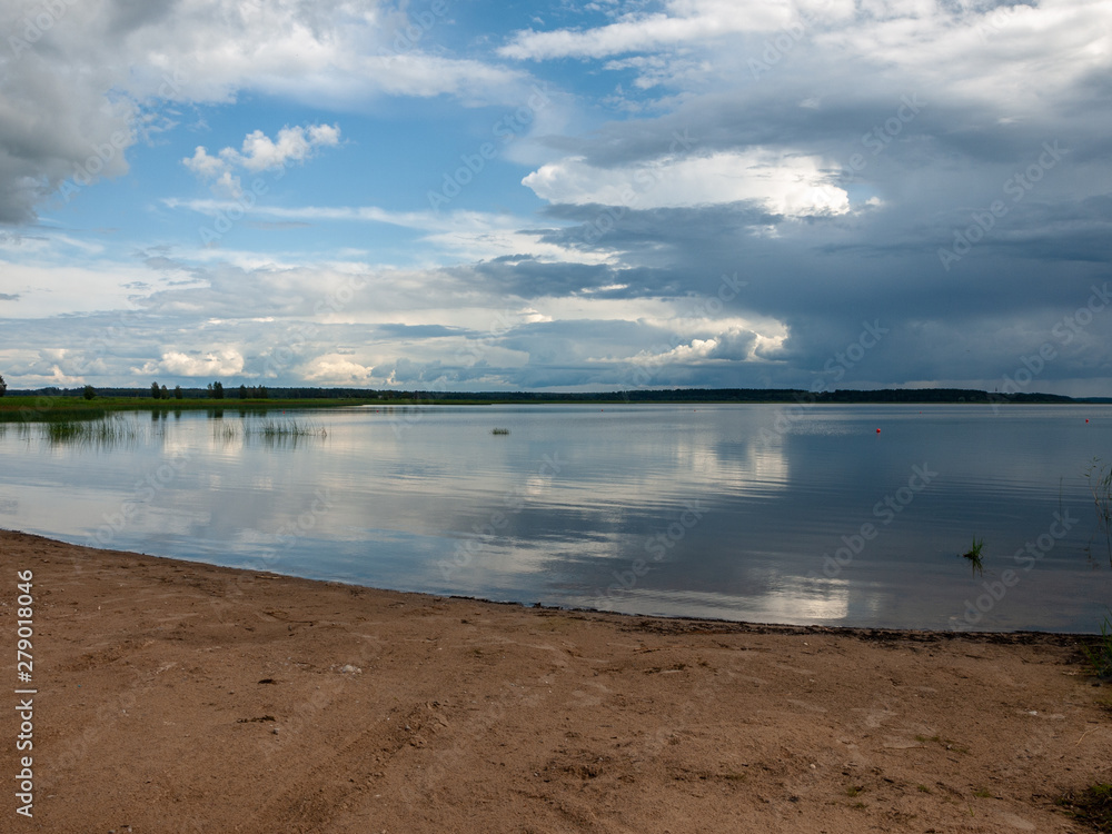 Storm clouds rolling in over peaceful lake,wonderful reflections, Lake Burtnieks, Latvia
