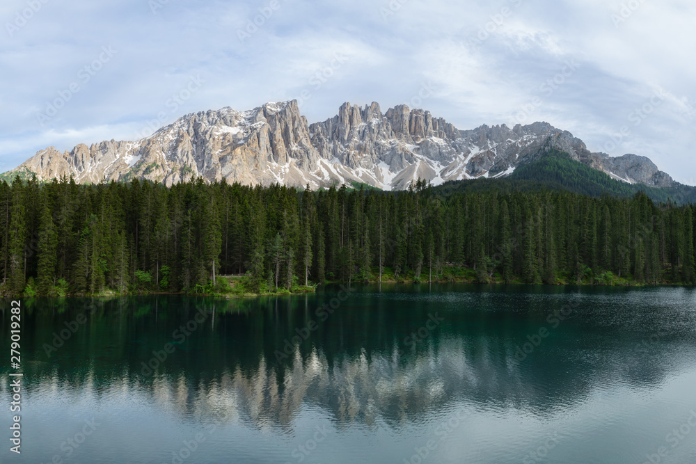 Panoramic view of Carezza Lake with reflecting in the water mount Latemar. South Tyrol, Italy