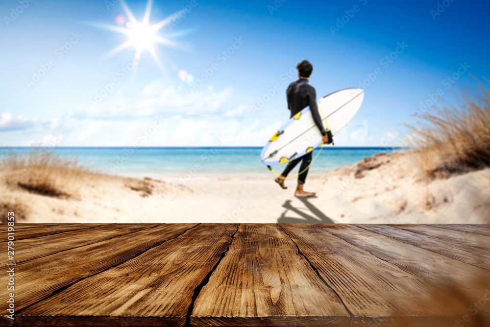 Table background with the beautiful ocean and beach view. Palm leaves frame. Blank space for a product.