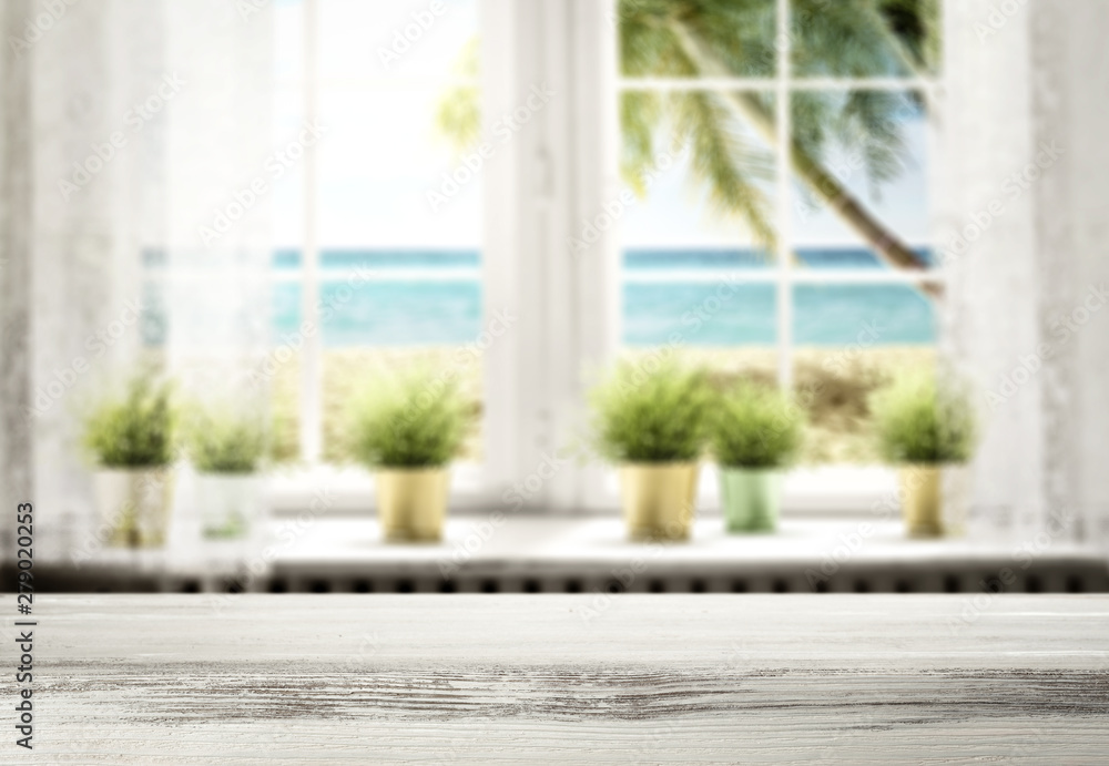 Table background and white window with ocean and beach view. Blank space for product Table background and white window with ocean and beach view. Blank space for product